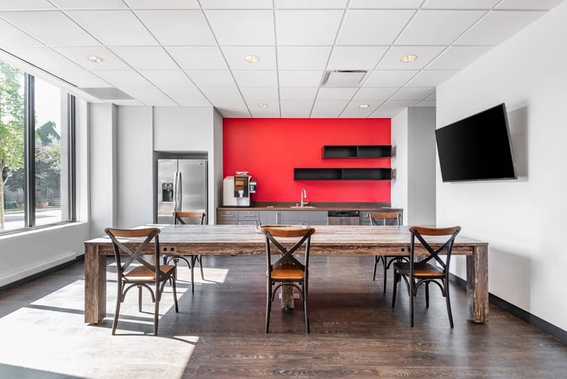 Modern meeting room with red accent wall, ideal for professional gatherings in Montclair.
