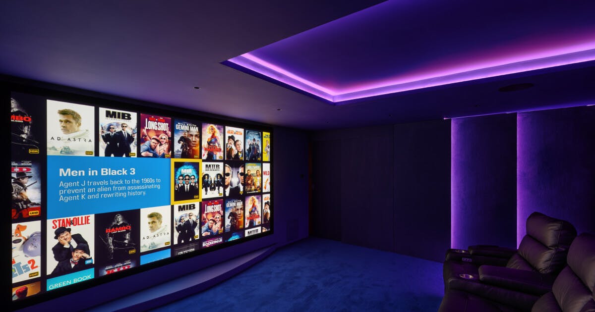 Modern screening room with movie posters, ideal for film screenings and corporate events.