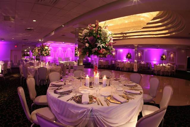 Elegant wedding hall with floral centerpieces and soft purple lighting in Richfield Regency.