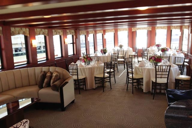 Elegant event space with round tables and floral centerpieces for corporate meetings.