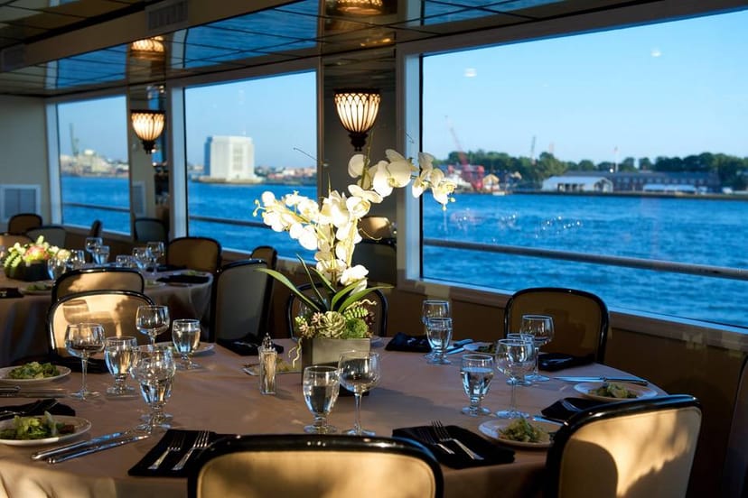Elegant boat dining setup with fine china for upscale events and corporate gatherings.