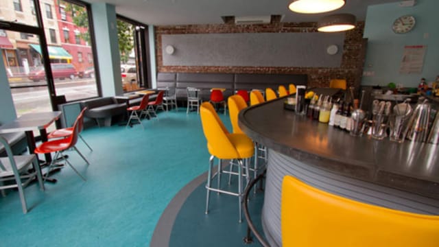 Vibrant lounge at Bearded Lady, ideal for casual meetings and events with colorful seating.