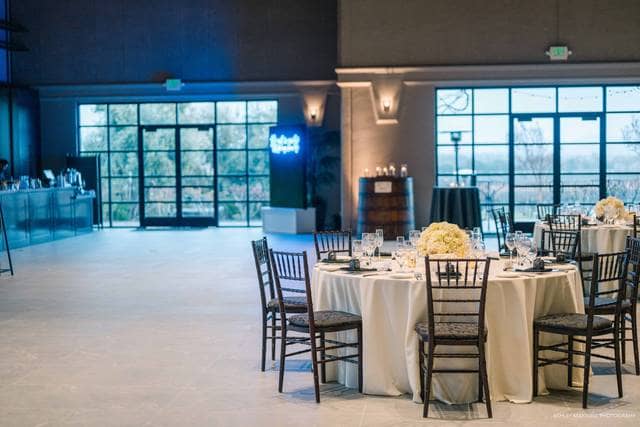 Elegant indoor event space with round tables, ideal for formal gatherings and celebrations.