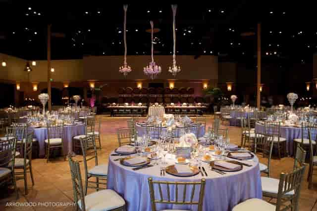 Elegant event space at The Palm Event Center with lavender tables, ideal for weddings.
