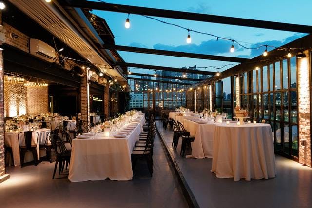 Elegant outdoor balcony with floral centerpieces for upscale weddings and events.