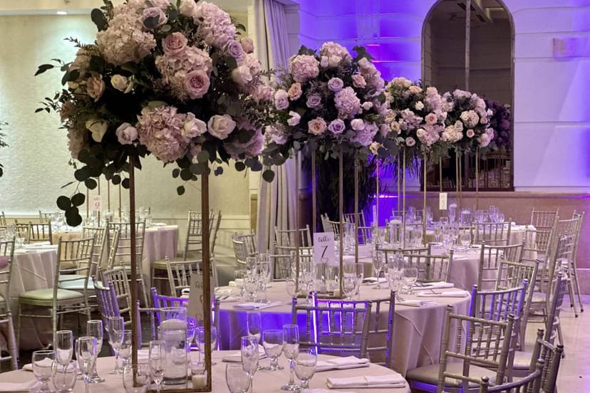 Elegant Main Reception Hall with round tables and floral centerpieces for weddings.