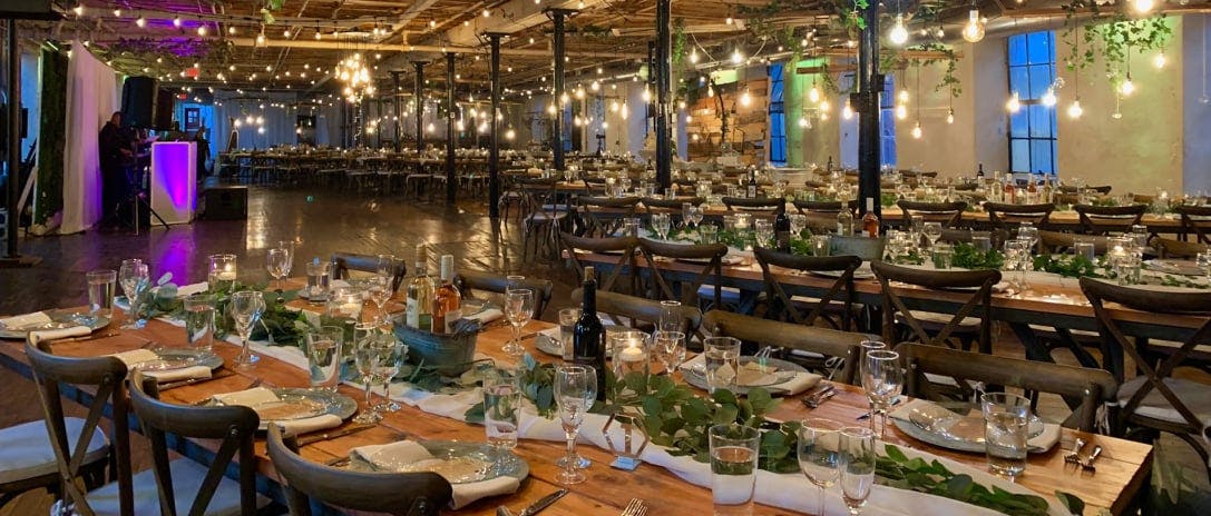 Elegant event space with wooden tables, ideal for sophisticated dinners and celebrations.