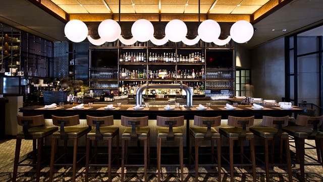 Stylish bar at Kimpton Hotel Eventi, perfect for networking events and informal meetings.