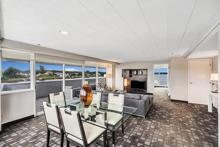 Modern meeting space in Oyster Point Hotel with glass dining table and scenic views.