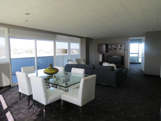 Modern meeting space in Oyster Point Hotel with glass table and natural light.