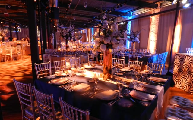 Elegant event space at Factory220 with dark blue linens for upscale weddings and trade shows.