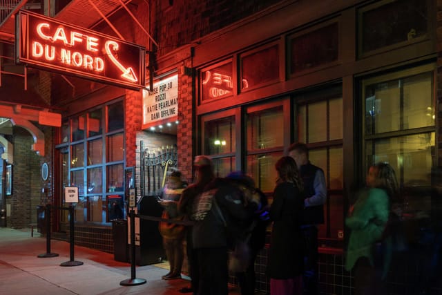 Vibrant Café du Nord terrace with neon lights, perfect for lively events and gatherings.