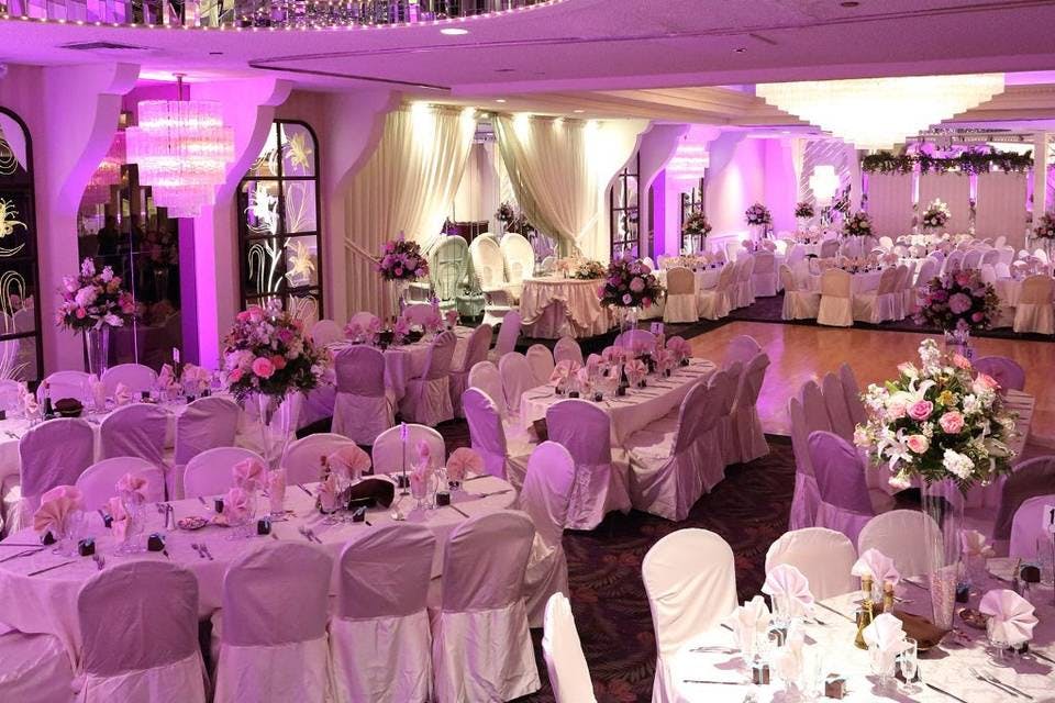 Elegant catering hall with floral centerpieces, perfect for weddings and formal events.