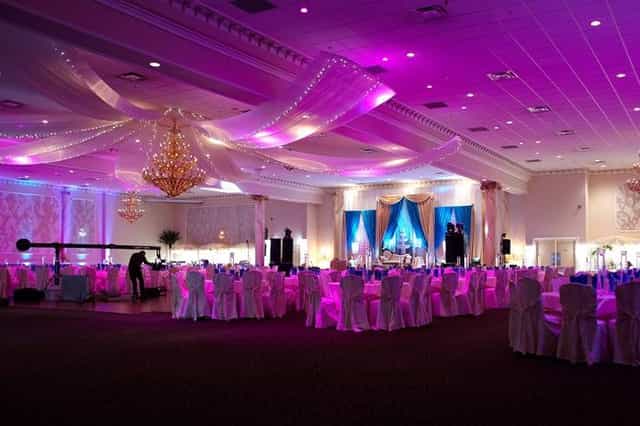Elegant catering hall with purple lighting, ideal for weddings and corporate events.