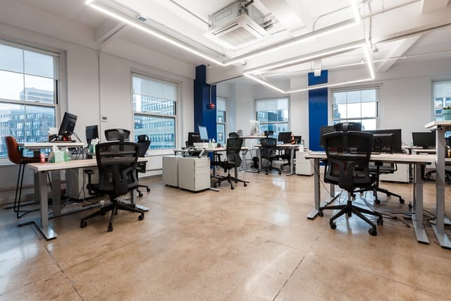 Modern open office space with flexible workstations for collaboration and events.