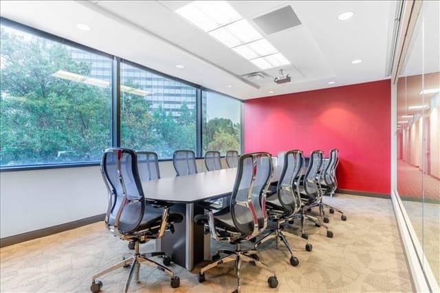 Modern conference room with large table, ideal for meetings and presentations.