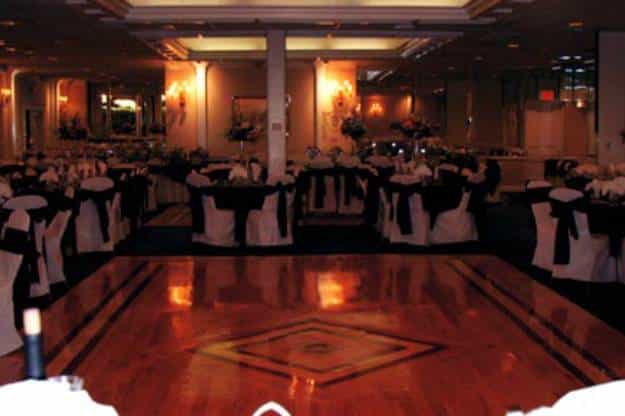 Elegant ballroom with black and white linens for golf outings and formal events.