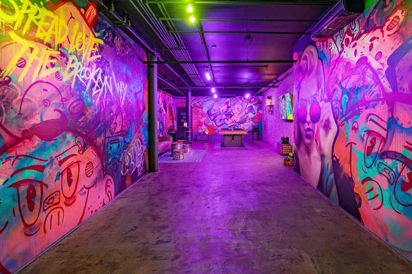 Vibrant urban event space with graffiti art, ideal for creative gatherings and workshops.