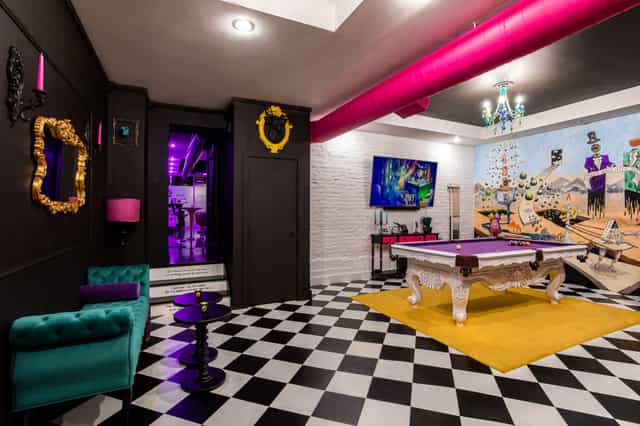 Vibrant private lounge with checkered floor for stylish networking events.