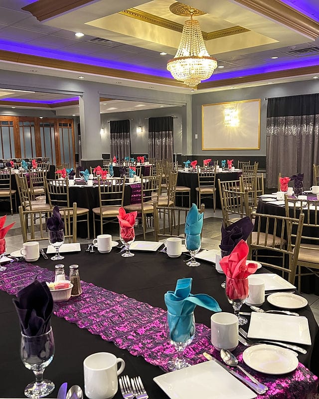 Elegant event space at Michael's Riverside Restaurant with vibrant table settings for celebrations.