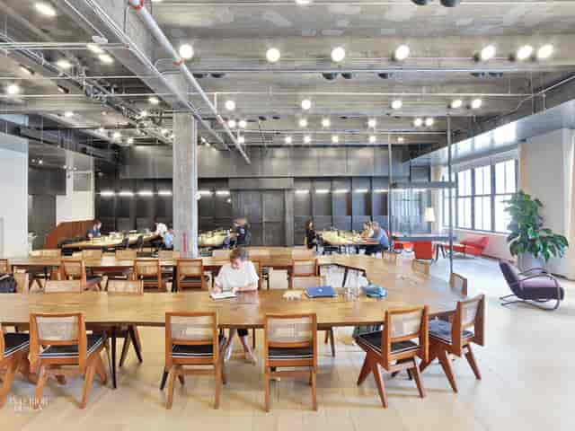 Modern meeting room at Spring Place, featuring a long wooden table for collaborative events.