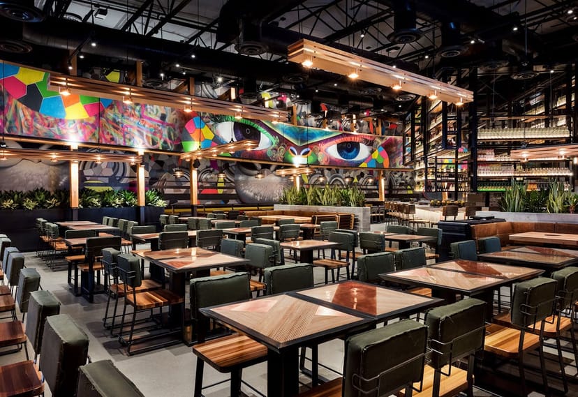 Chef's Table at Puesto Santa Clara with vibrant mural, ideal for networking events.