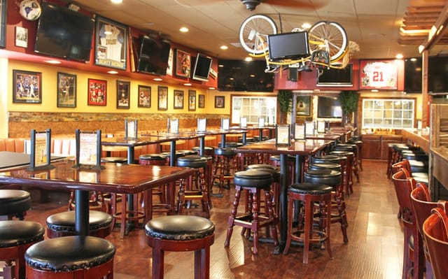 Vibrant sports-themed patio at Rookies Sports Lodge for casual meetings and events.