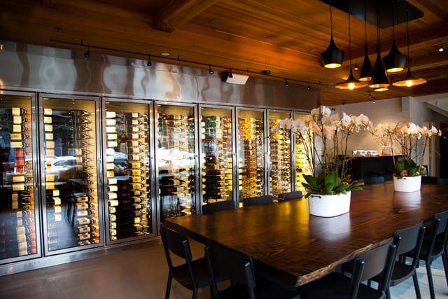 Sophisticated dining space with wine display, perfect for upscale events and wine tastings.