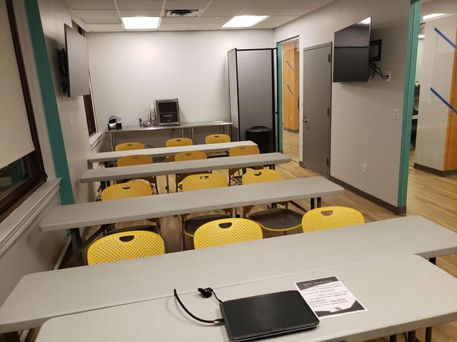 NYC conference center workshop room with yellow chairs, ideal for training sessions.