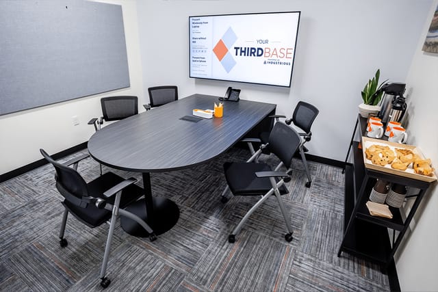 Modern meeting room with oval table, ideal for corporate events and presentations.