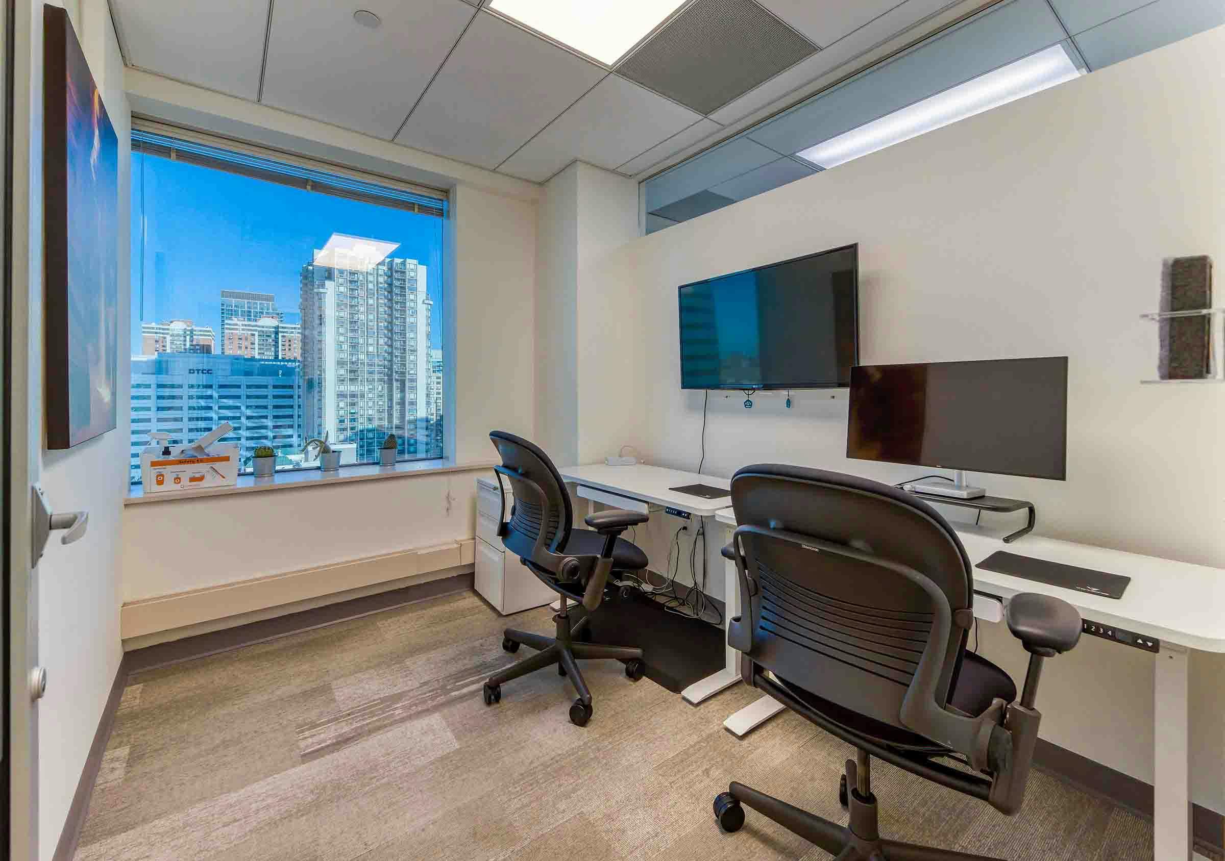 Modern coworking meeting room with city view, ideal for presentations and collaboration.