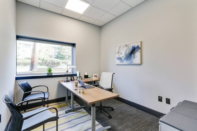 Modern meeting room with natural light for collaborative gatherings in Pompton Avenue Office Suites.