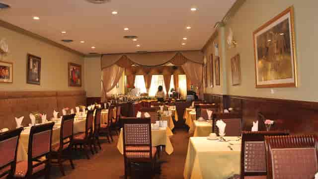 Elegant restaurant space with warm lighting for intimate meetings and events.