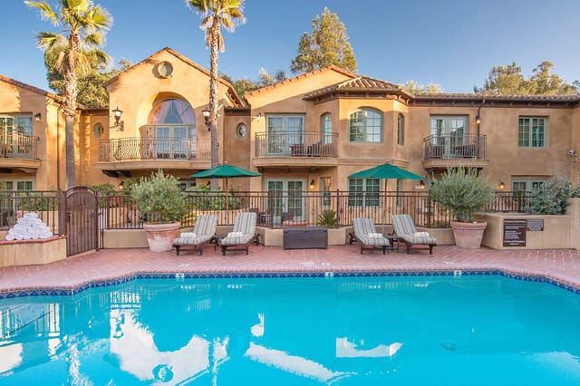 Poolside patio at Los Gatos Lodge, ideal for events with serene pool and lounge chairs.