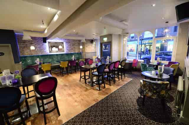 Vibrant bar venue with colorful seating for casual meetings and social gatherings.