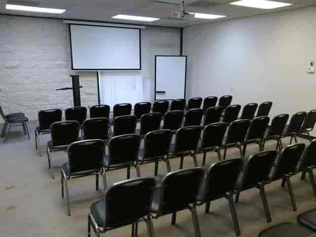 Functional conference room with black chairs for presentations and workshops.