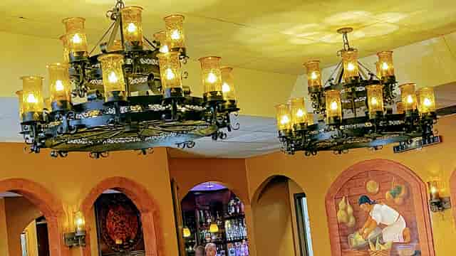 Elegant banquet hall in Casa Azteca with chandeliers, perfect for intimate events.
