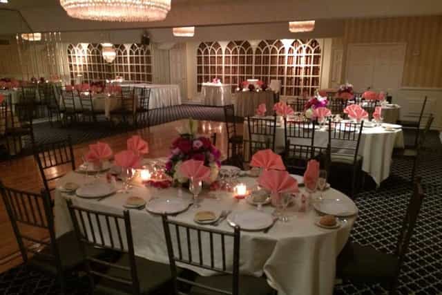 Elegant banquet hall with white linens, perfect for weddings and corporate events.