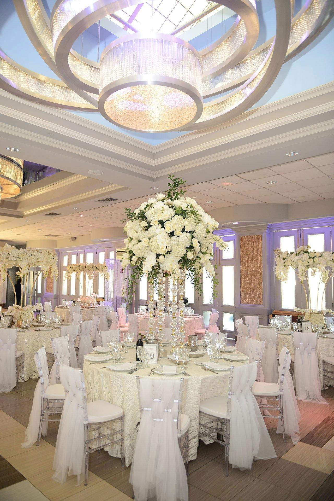Elegant Encore Ballroom with tall floral centerpieces for weddings and upscale events.