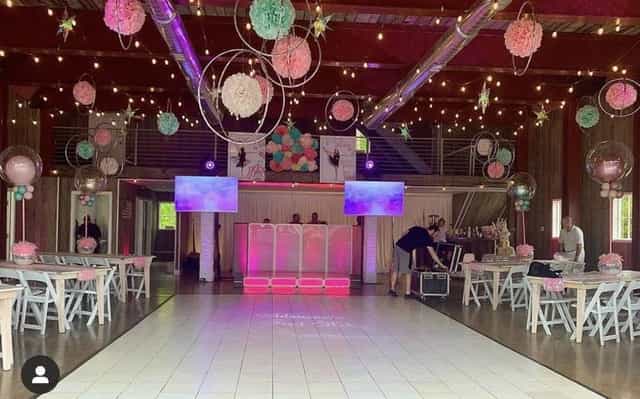 Outdoor party space in The Barn, decorated in pink and mint green for weddings and events.