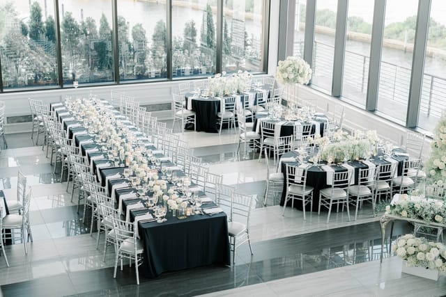 Elegant banquet hall setup with black and white decor for corporate events.