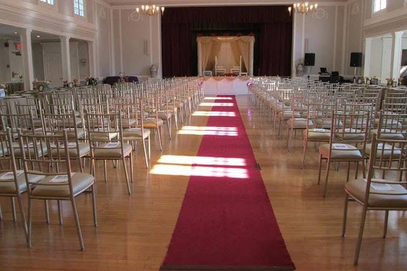 Elegant ballroom with red carpet, perfect for weddings and formal events.