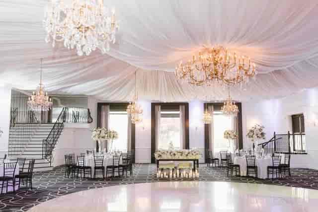 Elegant event space with grand chandelier, perfect for weddings and corporate events.