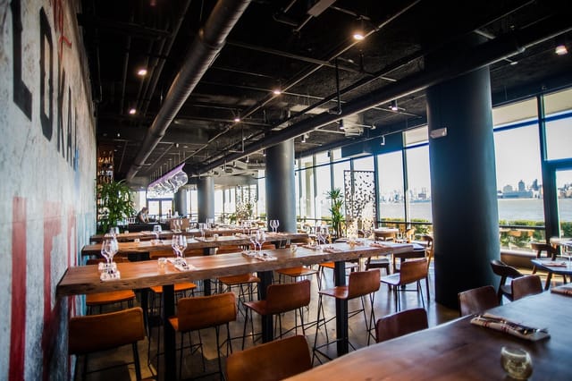 Indoor dining area with large windows at Lokal Eatery & Bar for events and gatherings.