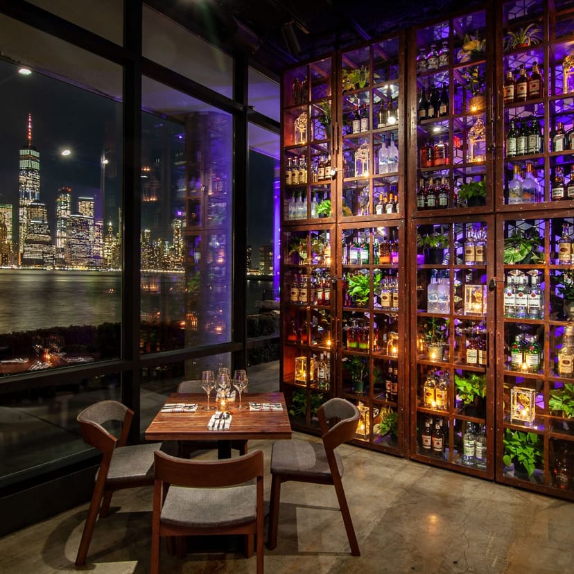 Indoor dining area at Lokal Eatery & Bar with skyline view, ideal for upscale events.