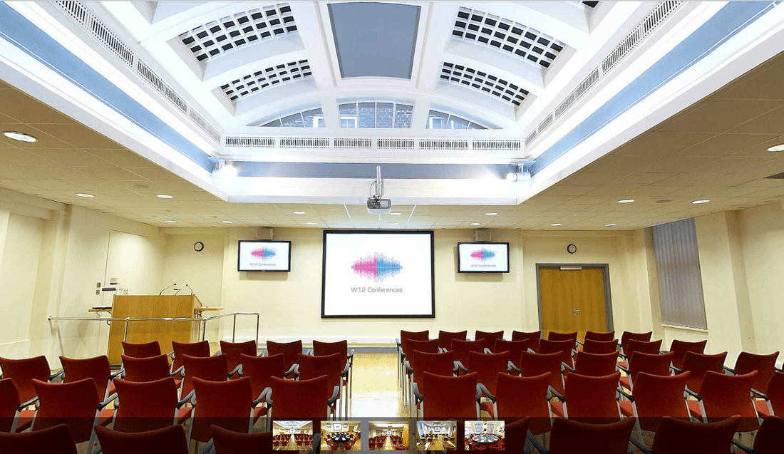 Conference room with red seating, ideal for meetings and events at W12 Conferences. - Banner