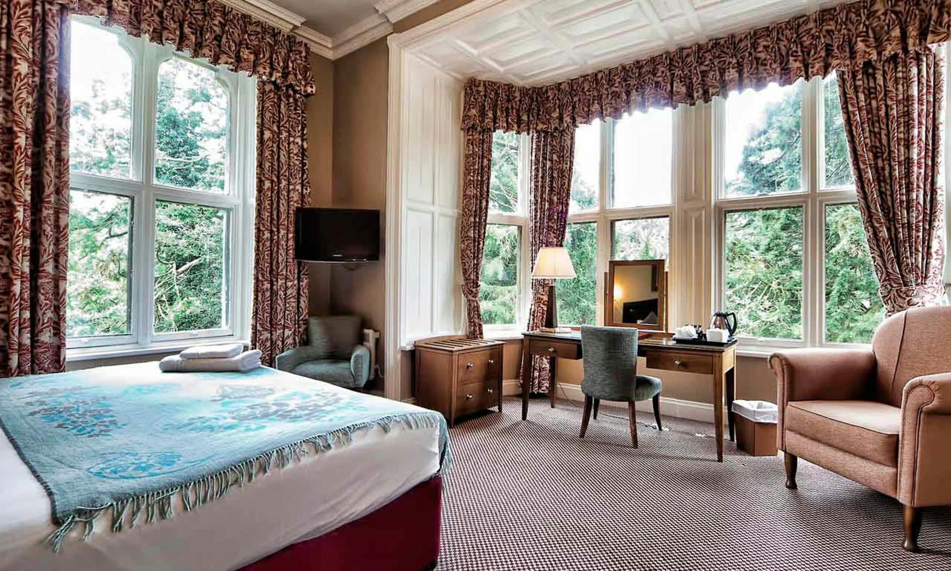 Gothic Manor hotel room with natural light, ideal for meetings and retreats.