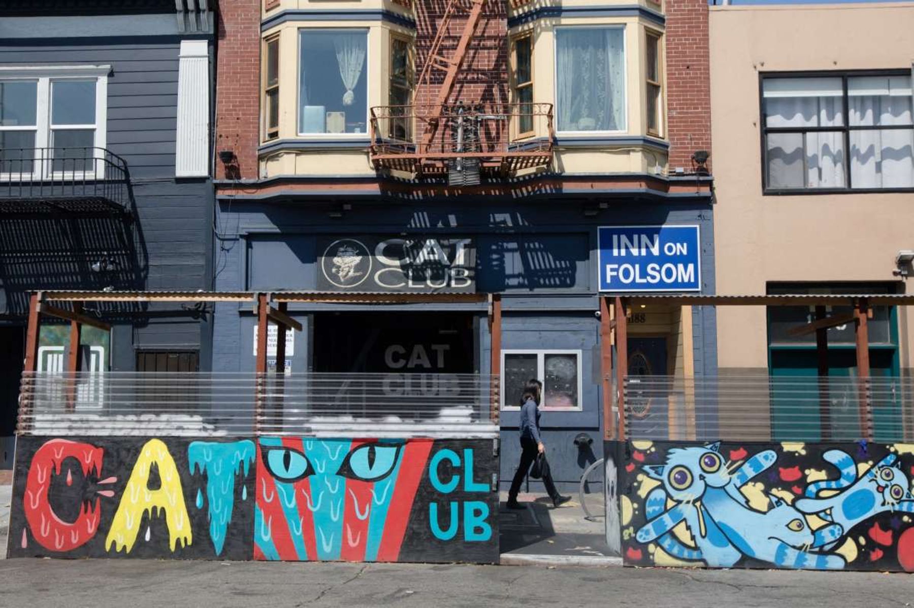 Vibrant Cat Club lounge with colorful mural, ideal for unique events and gatherings.