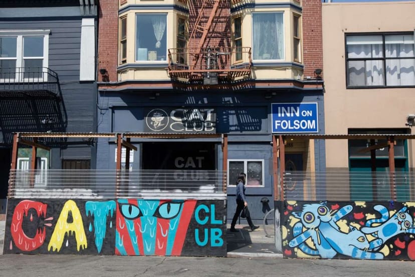 Vibrant Cat Club lounge with colorful mural, ideal for unique events and gatherings.