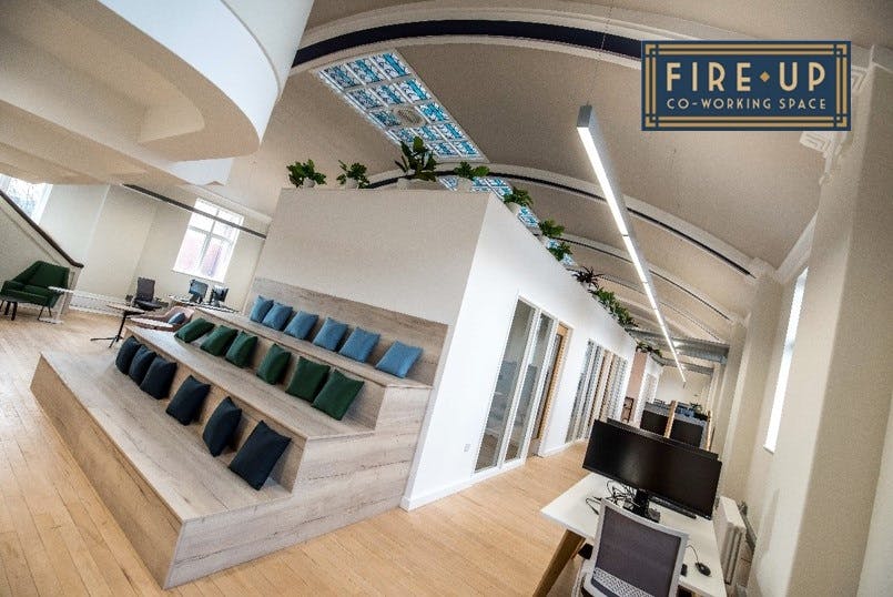 Modern co-working space with tiered seating for flexible meetings and events in Rochdale.